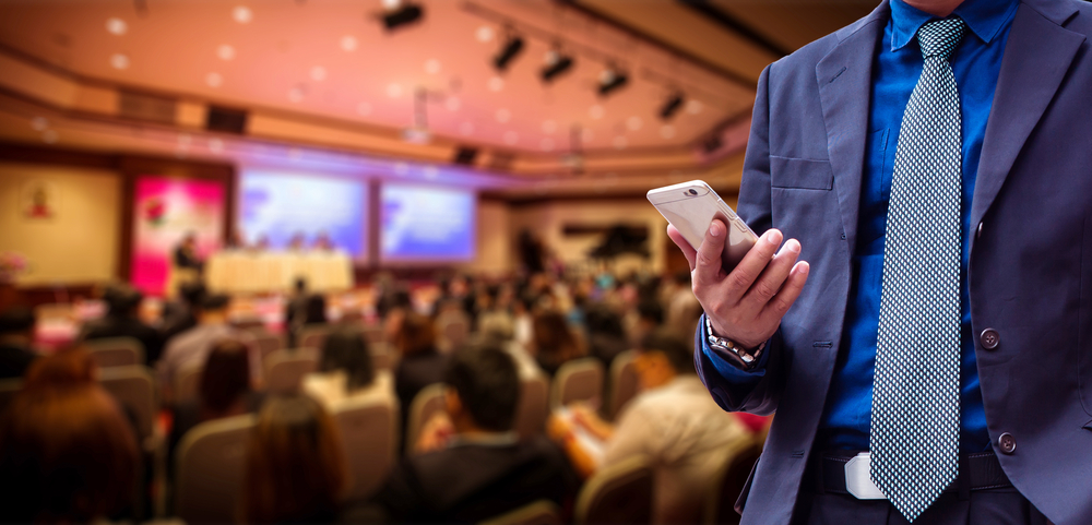 man using custom app for conference event